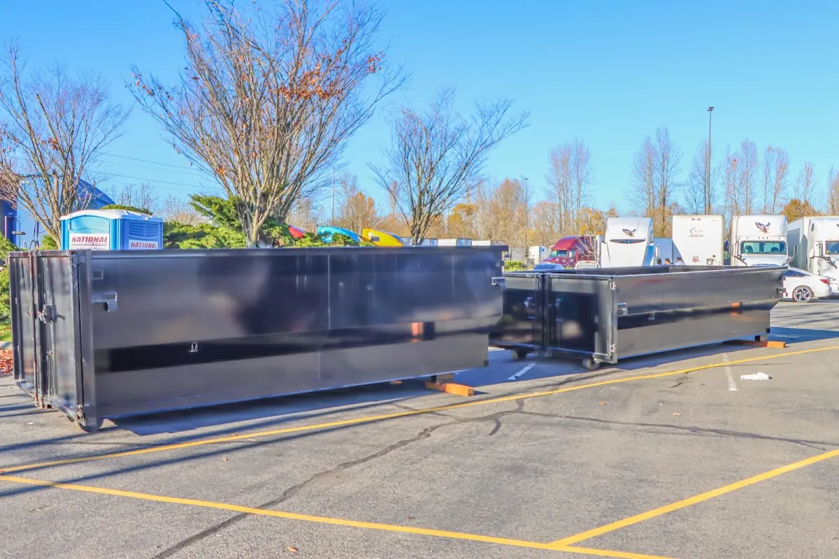 Professional dumpster rental service with roll-off container on residential driveway in Pleasant Valley